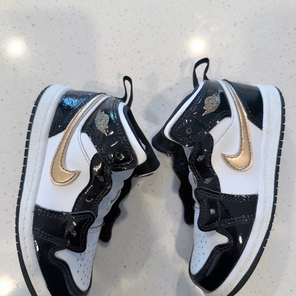 Kids Black, White & Gold Low-Top Jordan Sneakers